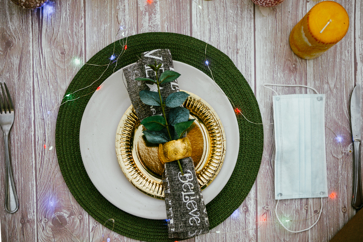 Christmas Holiday Dinner Place Setting - Plates, Napkin, Cutlery, Gold Bauble Decoration in covid times. SUrgical mask