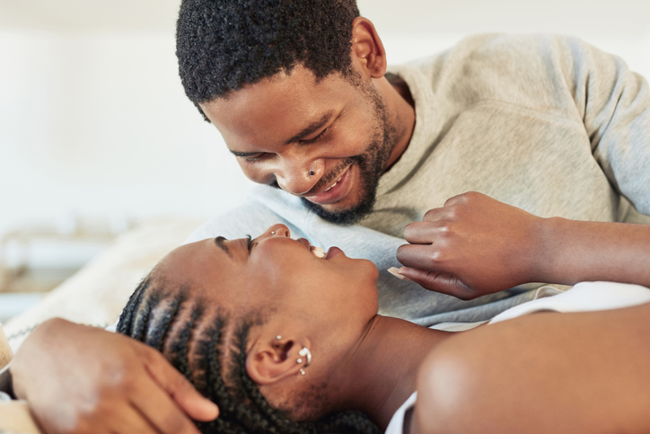 Shot of a young couple being intimate in bed at home