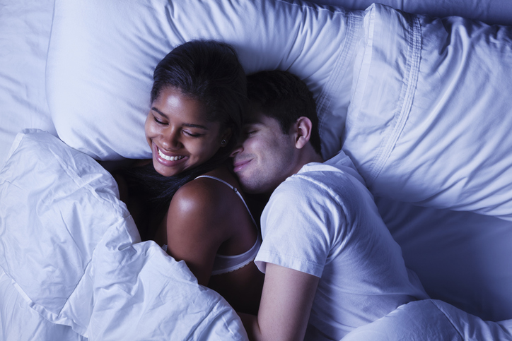Happy Young Couple in Bed