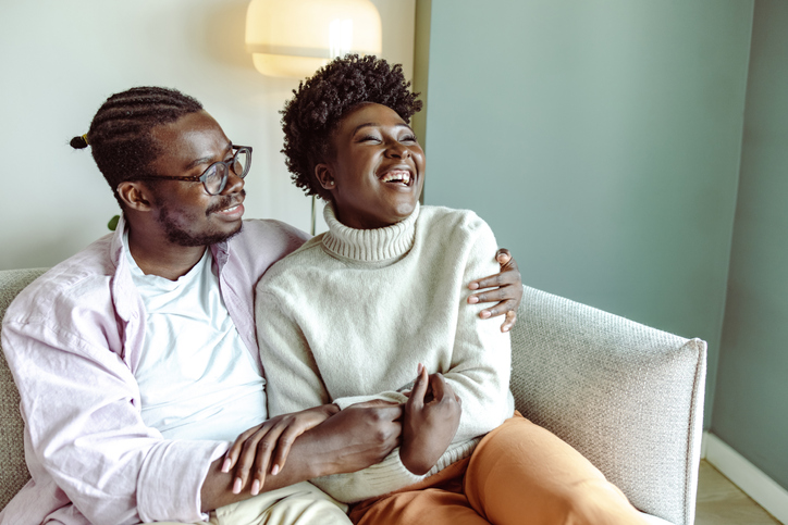 Happy African-American couple embracing at home
