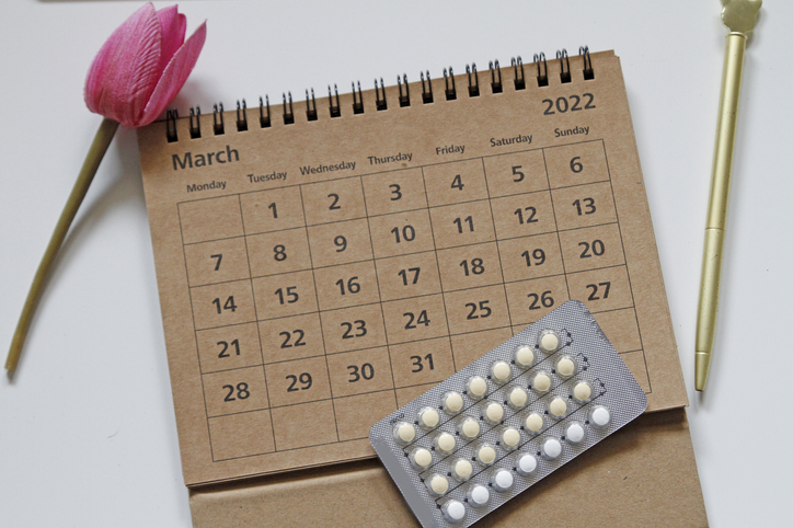 Contraceptive pills in blister pack on calendar