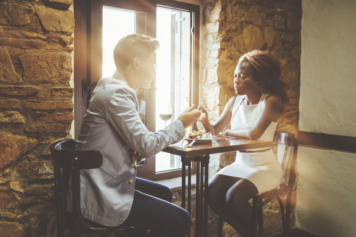Young couple eating in a bar.
