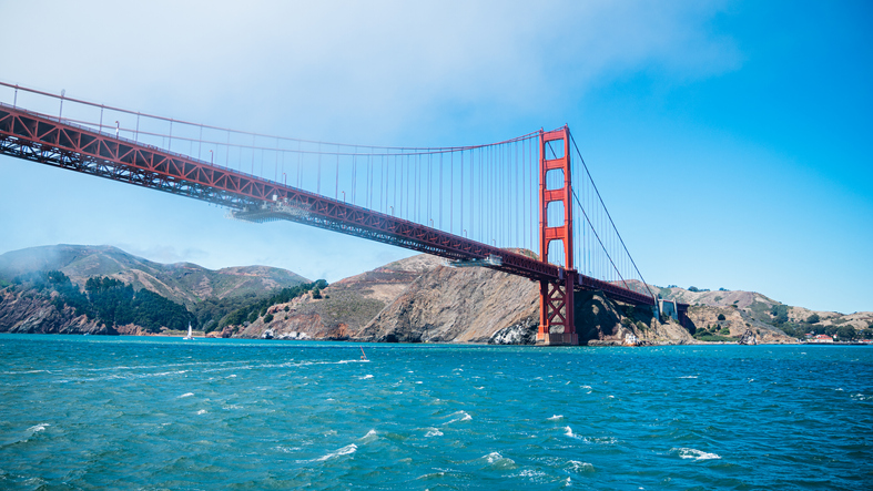 The Golden Gate Bridge Above The Water And Covered In Fog.