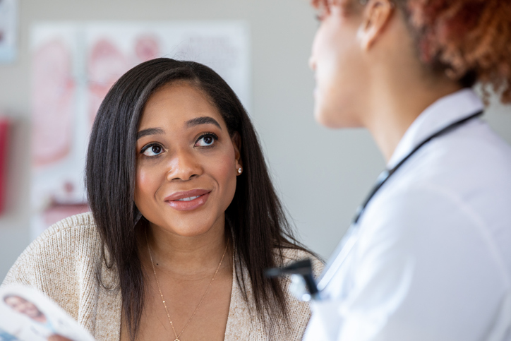 Young woman and her doctor are discussing healthcare options during appointment