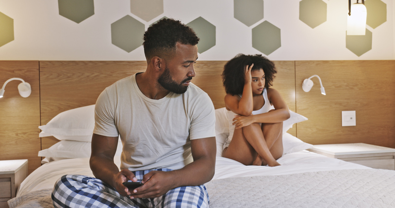 Boyfriend texting on phone, signing up on dating app, having affair after fight with girlfriend in home bedroom. Sneaky husband ignoring, hiding, cheating on wife. Technology and couple infidelity