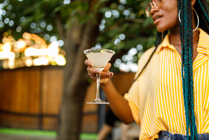 Cut out shot of young woman enjoying a delicious margarita cocktail during a garden party