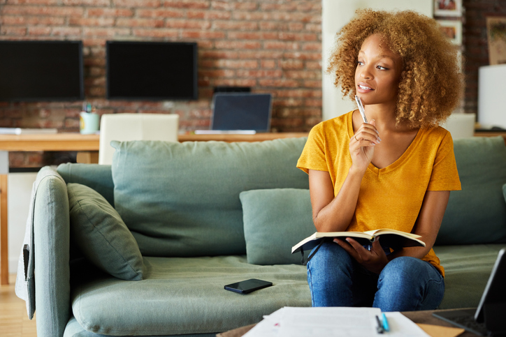 African American Businesswoman With diary and Pen at Home