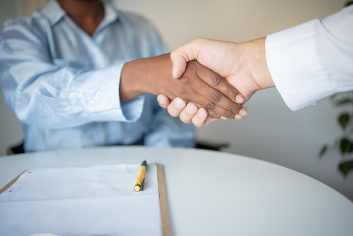 Real estate agent passing keys to his client