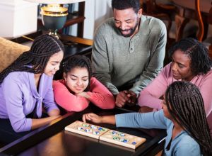 African-American family at home playing board game