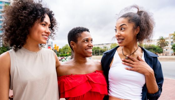 Three mixed race hispanic and black women bonding outdoors exchanging gossip