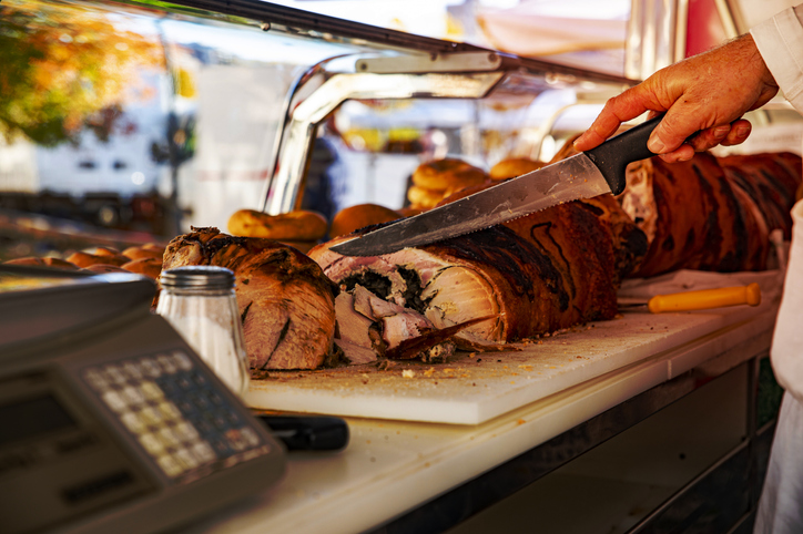 peddler while cutting the pork