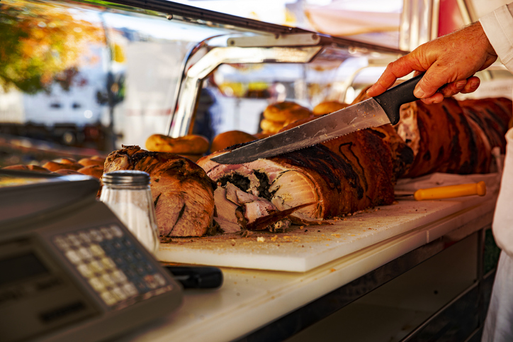 peddler while cutting the pork