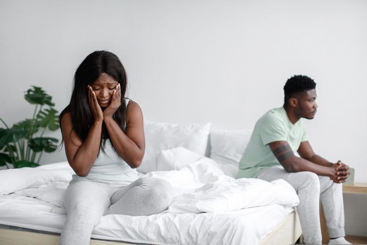 Depressed frustrated young african american wife sad and crying after quarrel, ignoring husband