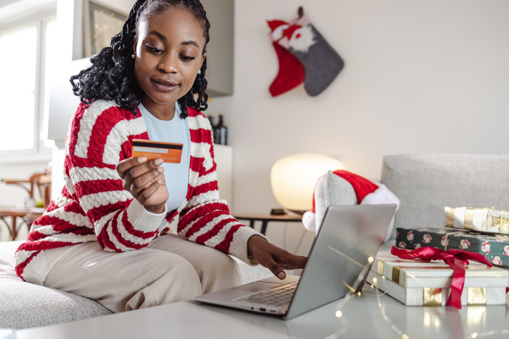 Young woman doing online Christmas shopping