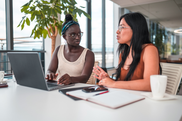 Young Latin Female Human Resources Manager Working With A Black Female Colleague