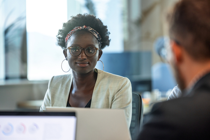 Portrait Of A Dark-skinned Female Manager Talking About Projects At The Office