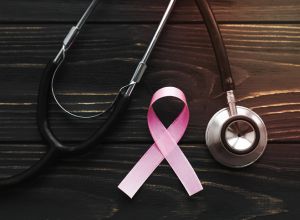 pink ribbon stethoscope dark background