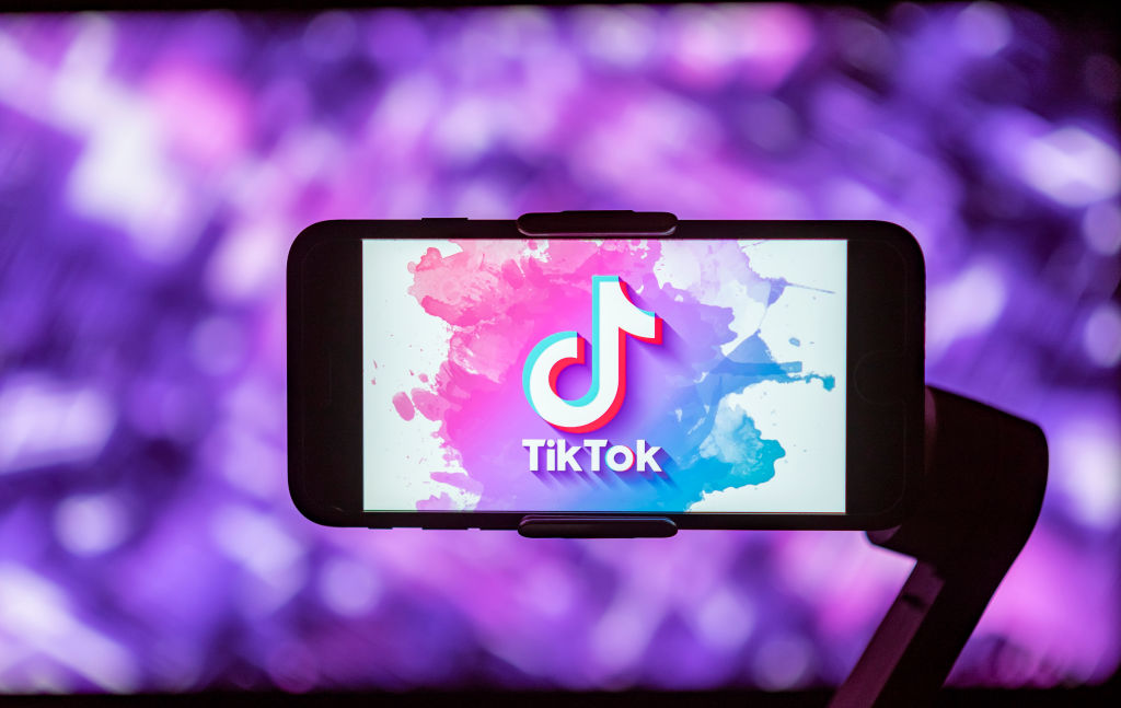 In this photo illustration, a TikTok logo is seen displayed...