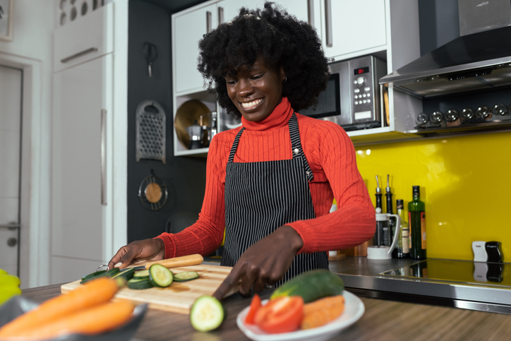 Portrait of a beautiful African American vegan preparing fresh veggies