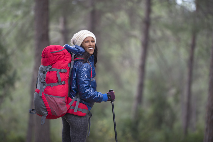 Backpacker woman hiking in mediterranean winter.
