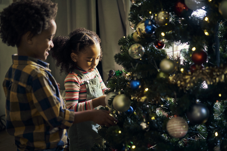Christmas tree decorating, kids and home, celebration and living room, house and celebrate xmas holiday. Happy, excited and young boy, girl and black children, festive trees decoration and ornament, avoiding holiday hazards