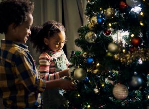 Christmas tree decorating, kids and home, celebration and living room, house and celebrate xmas holiday. Happy, excited and young boy, girl and black children, festive trees decoration and ornament, avoiding holiday hazards