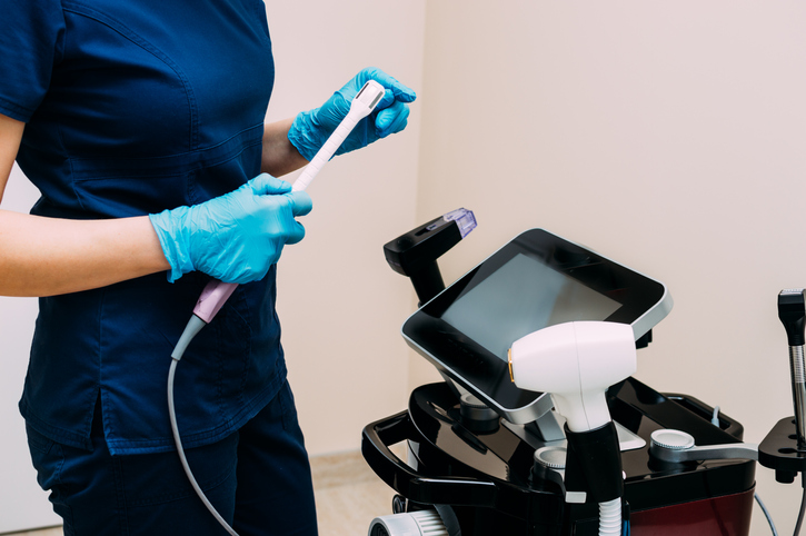Aesthetic gynecology. Intimate rejuvenation. doctor works with the device