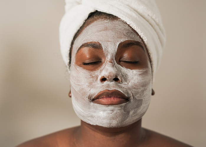 Young african girl doing spa day with sking care beauty treatment