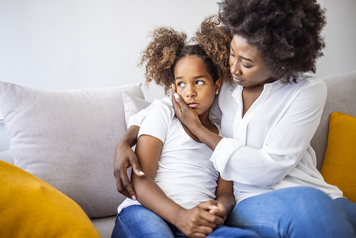 Loving worried mom psychologist consoling counseling talking to upset little child girl