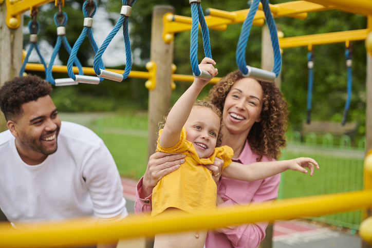 family playing on a climbing frame