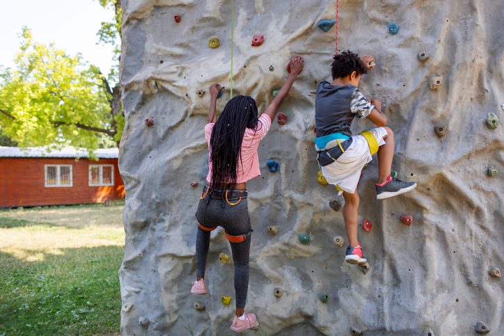 Mother And Son Enjoy Wall Climbing Together