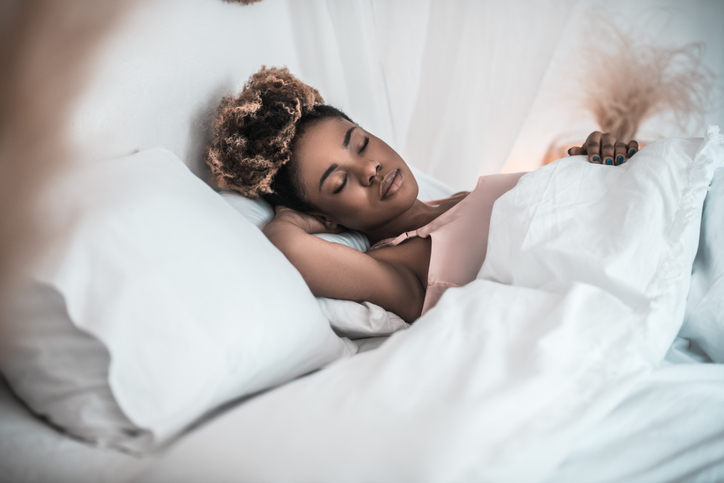 African american woman sleeping soundly in bed