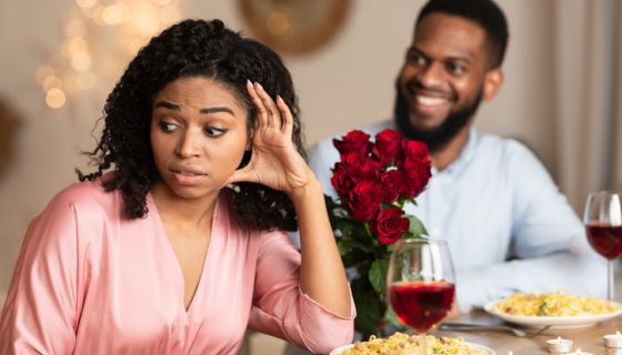 Black Woman On Unsuccessful Date In Restaurant wondering how to cut a date short