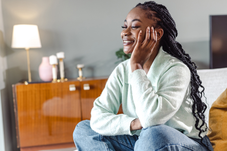 Beautiful smilling woman sitting in her living room