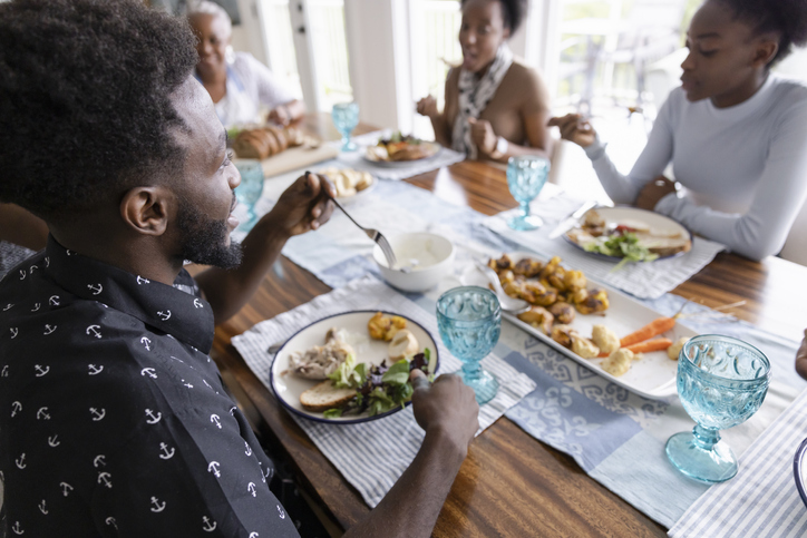 Multigenerational family eating dinner together at dining table