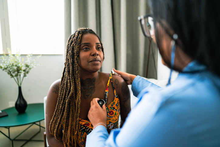 female doctor analyzing patient's heartbeat