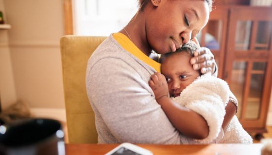 Single Black Mother Caring young mother holding her little girl in her arms