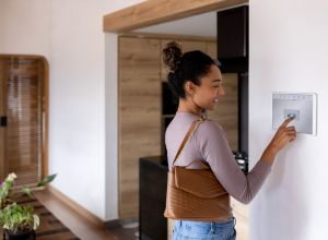 Woman leaving her smart home and closing the door using an automated system. living alone emergency safety