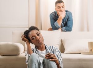 frustraited couple beside couch having a bad day