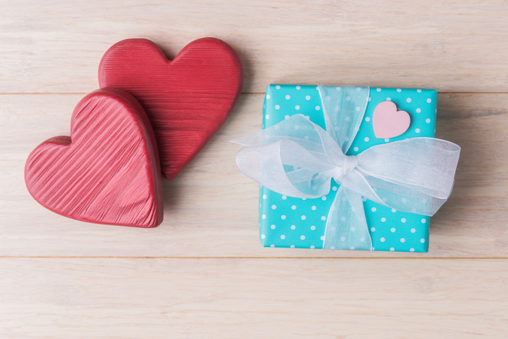 Gift box and decorative Valentines hearts on wooden background. ValentineâÂ€Â™s day greeting concept