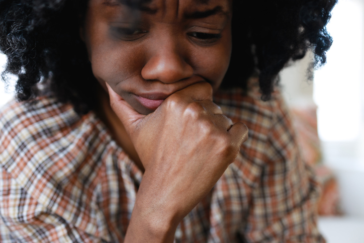 Distraught Woman Rests Her Chin on Hand