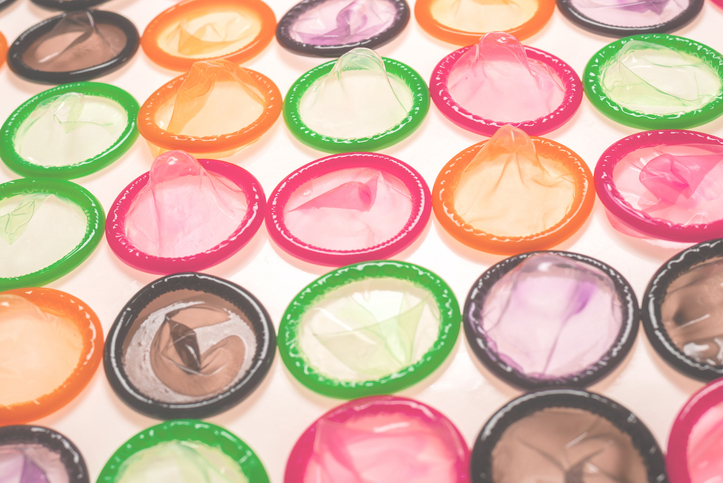 Colorful condoms background. different types of condoms