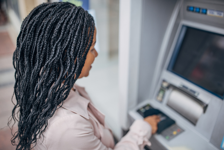 Woman using ATM machine