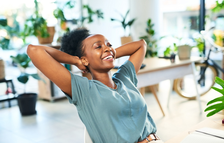 Black woman stretching in office to relax at desk from easy project deadline, achievement and smile for business future. Hands behind head, happy worker and finish job goals, happiness and motivation