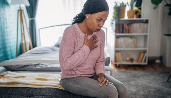 Woman having chest pain heart attack symptoms