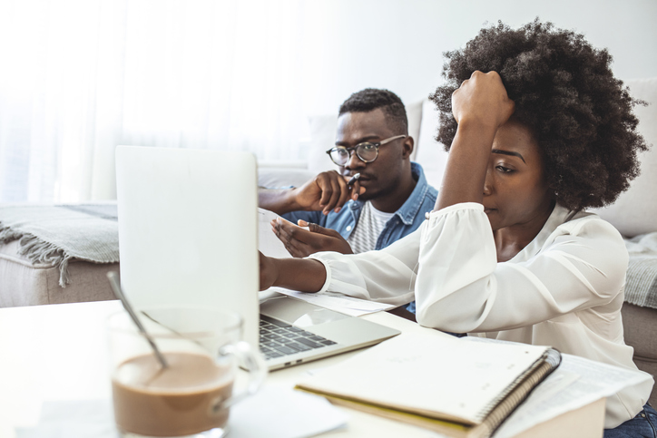 Stressed african american couple looking frustrated