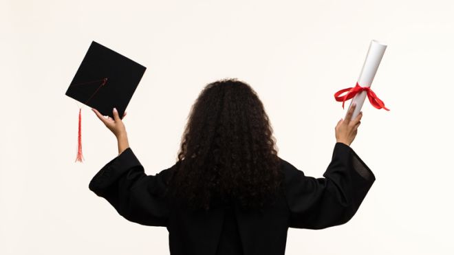 African american woman in graduate dress and mortarboard