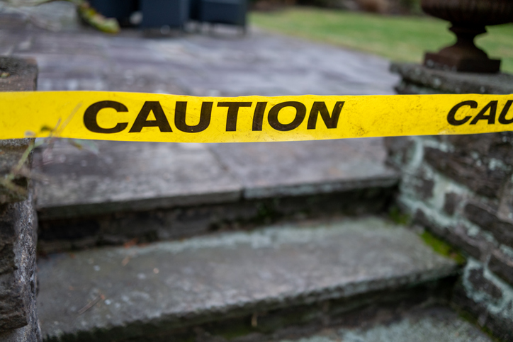yellow plastic caution tape in front of slate steps