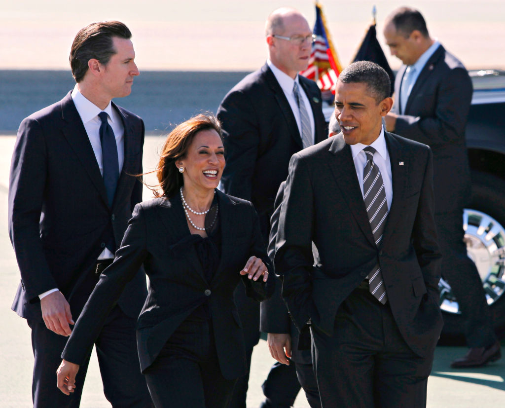 President Barack Obama walks with Attorney General Kamala Harris, Lt. Gov. Gavin Newsom and Mayor Ed Lee (not seen) after his arrival aboard Air Force One at SFO in San Francisco, Calif. on Thursday, Feb. 16, 2012 to attend private fundraising events this