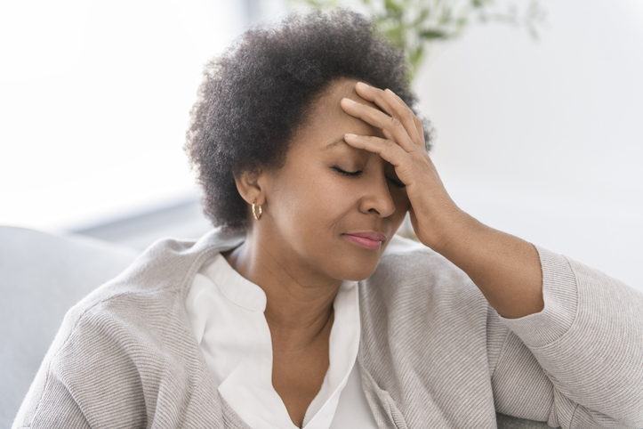 Black woman sitting on sofa at home have bad time